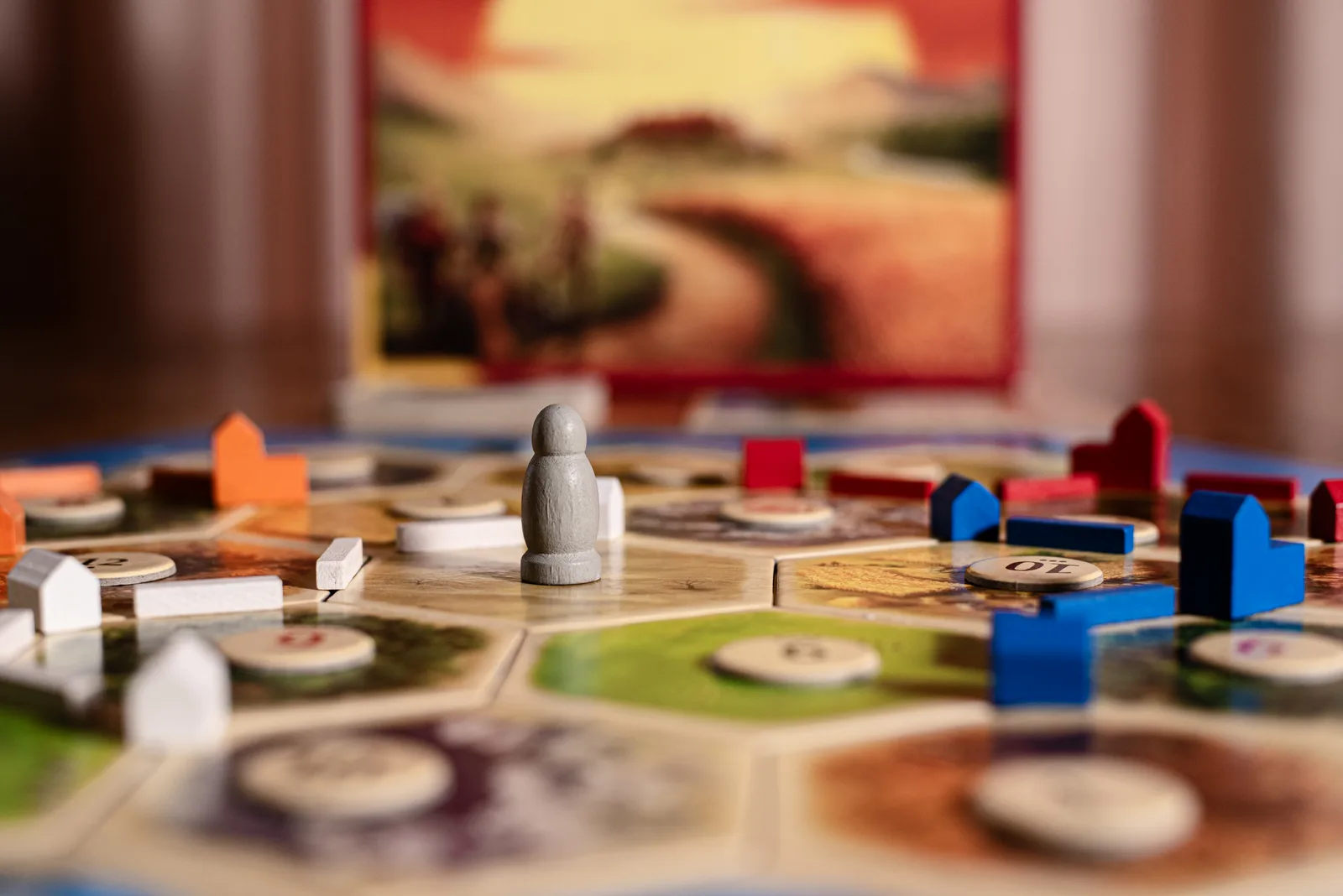 A game of Catan part-way through, houses and roads in four colours across the hexes